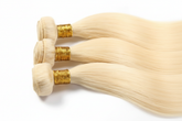 Enhanced three-bundle platinum blonde hair flat lay